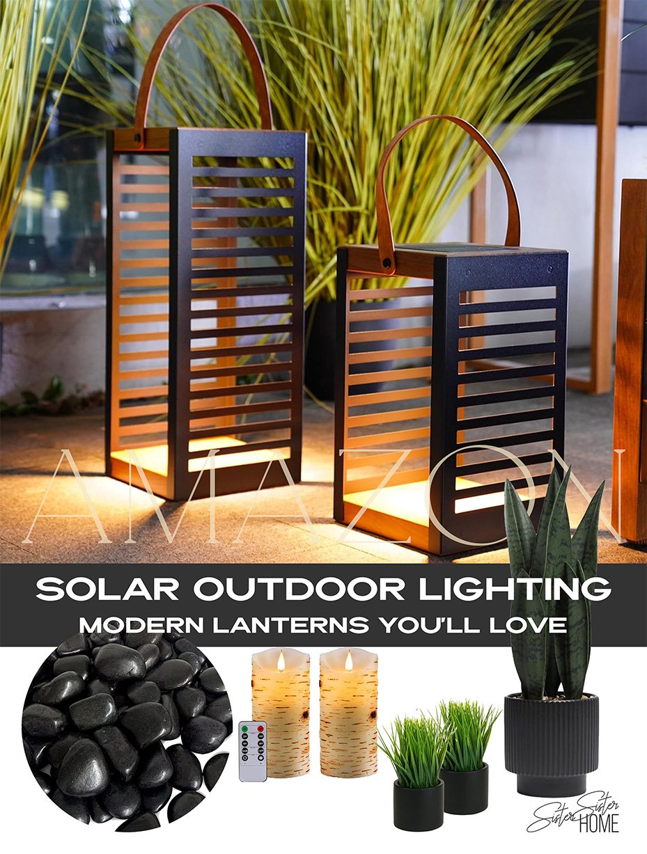 Modern solar outdoor lighting ideas featuring black metal lanterns, artificial greenery, flameless candles, and polished river pebbles for a stylish and cozy patio setup