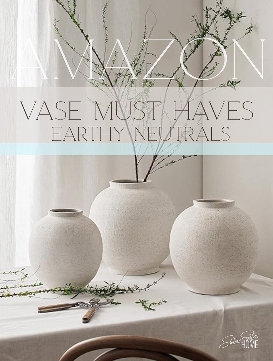 Three white ceramic vases with an earthy matte texture styled on a neutral linen table with greenery stems; text overlay reads “Amazon Vase Must Haves – Earthy Neutrals.