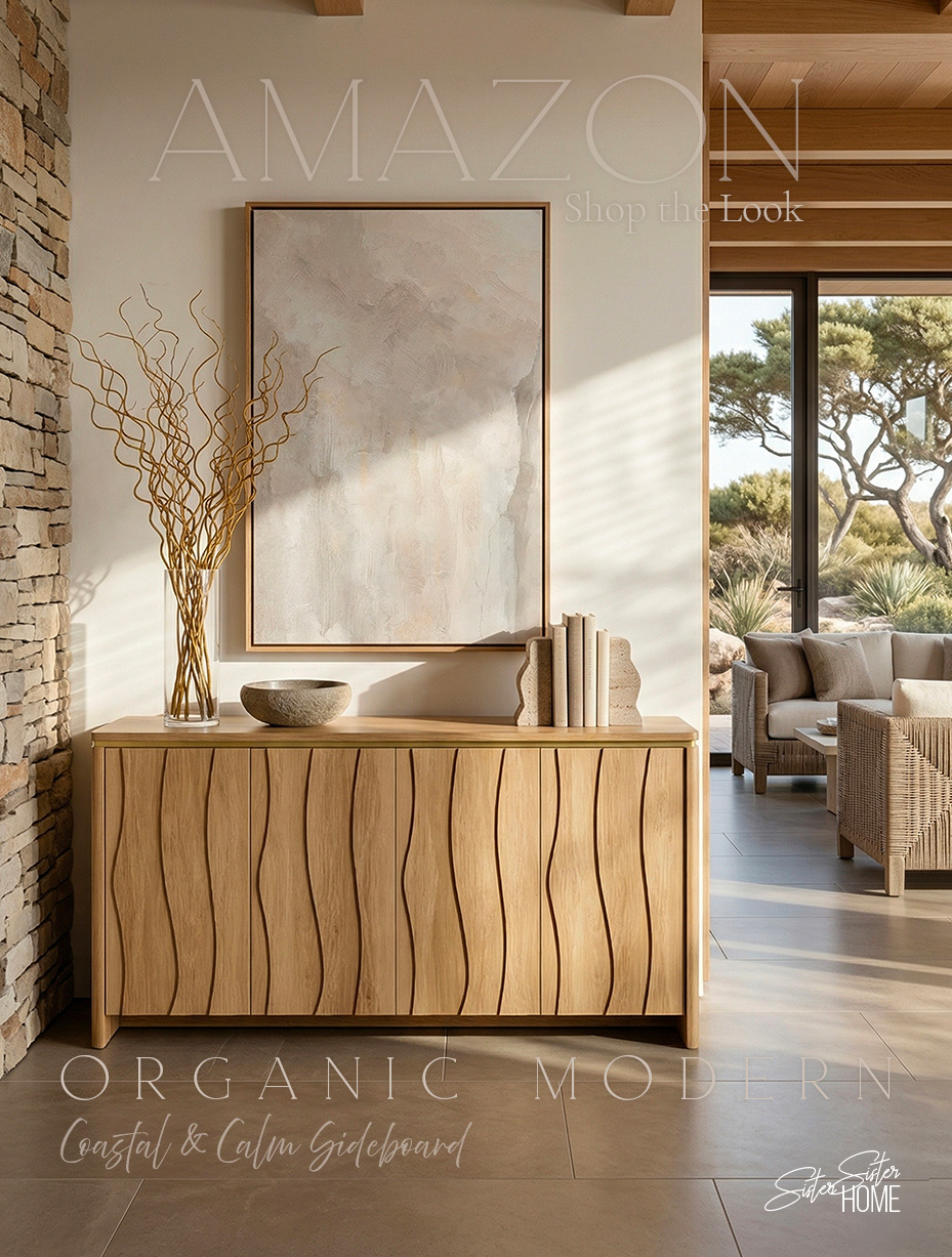 Organic modern sideboard styled with neutral abstract art, glass vase with curly willow branches, stone bowl and books in a coastal calm living space