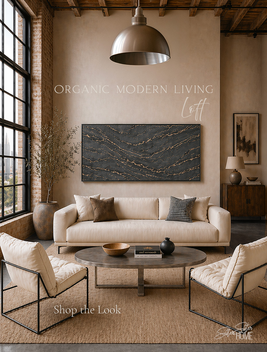 Organic modern living room loft with cream sofa, boucle accent chairs, jute rug, metal coffee table, and large abstract wall art