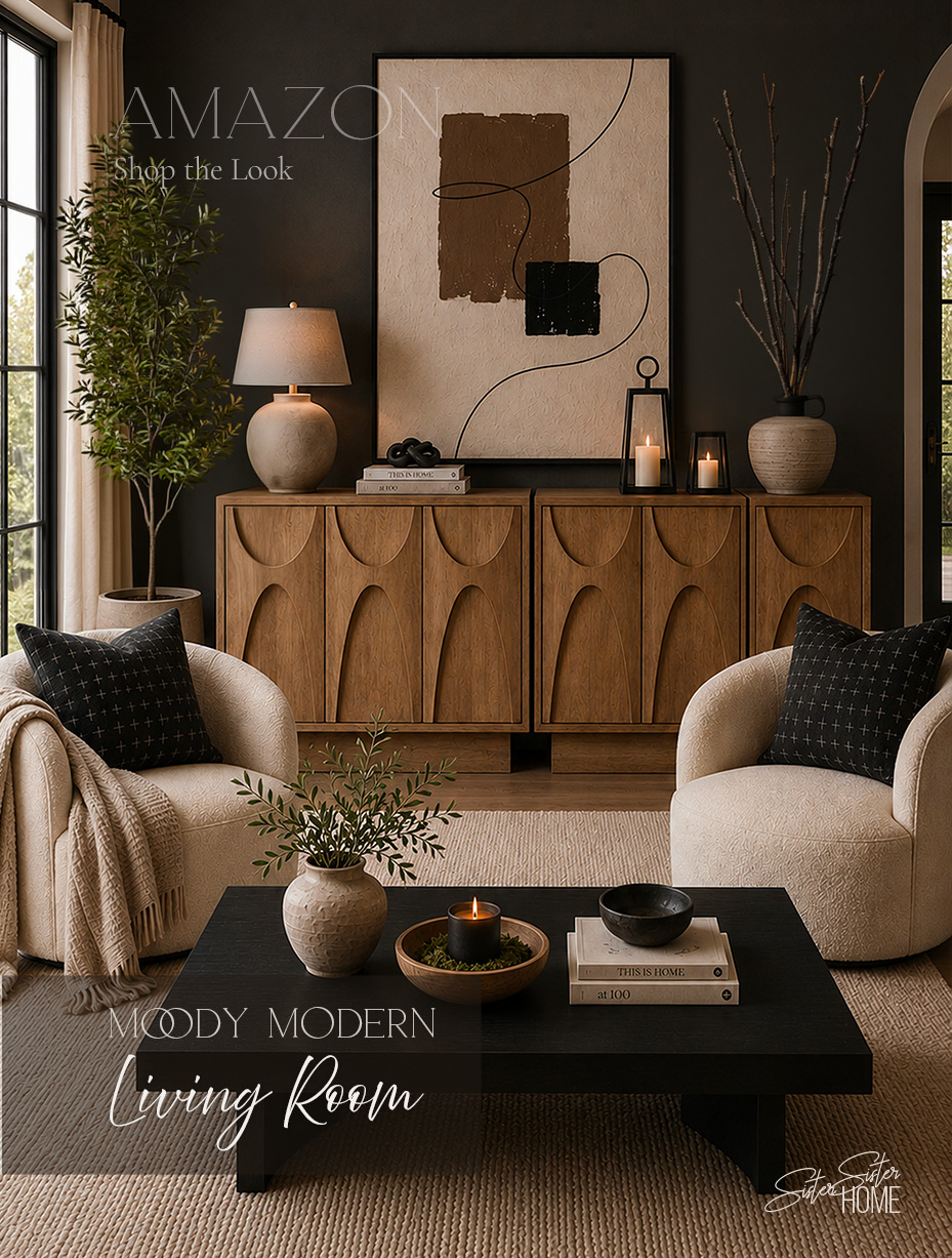 Moody modern living room with carved wood cabinets, ivory bouclé chairs, black coffee table and neutral abstract wall art.