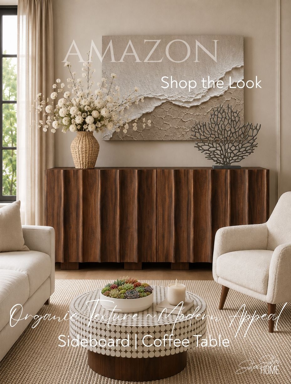 Modern organic living room with sculptural walnut furniture, textured artwork, neutral seating and handcrafted décor.