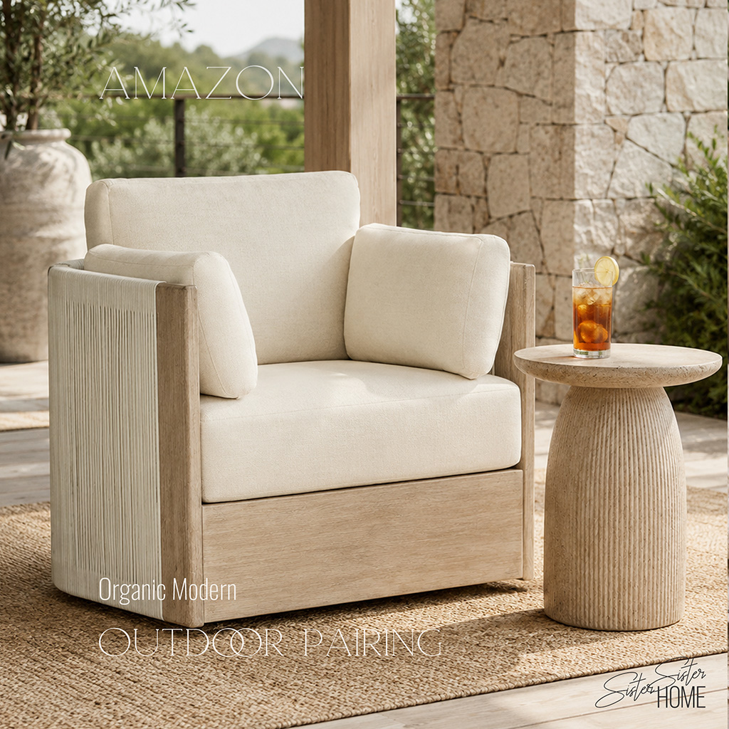 Organic modern outdoor chair and fluted side table styled on a covered stone patio.