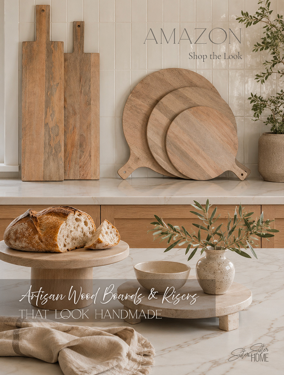 Warm organic modern kitchen featuring artisan-style mango wood serving boards, charcuterie boards, a footed riser, and a wood pedestal stand.