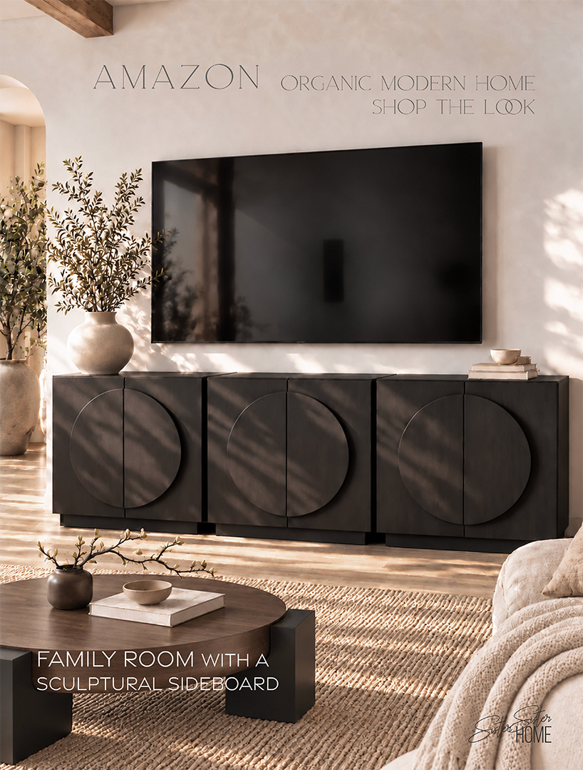 Sunlit organic modern family room with three espresso sculptural sideboards beneath a large TV, an ivory olive-branch vase, round walnut coffee table, and partial cream sofa.